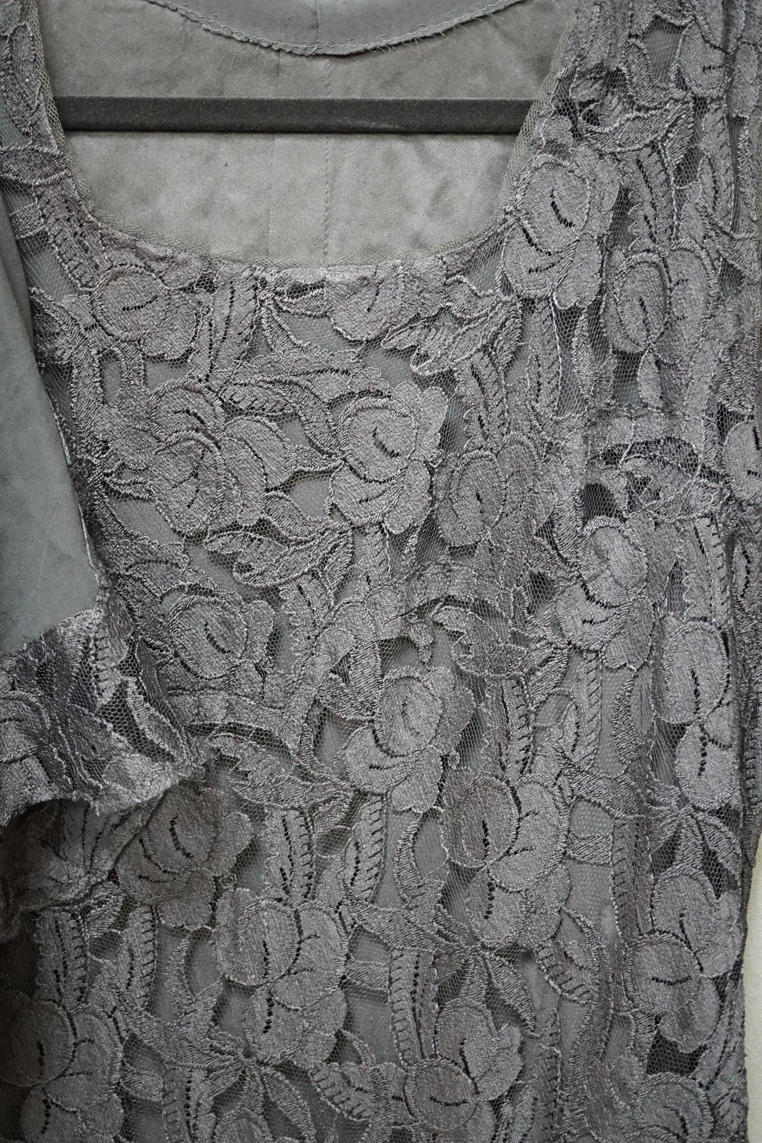 A 1930s black lace evening dress and matching jacket, together with a black taffeta and lace evening dress, the lace dress with bias cut panels and sheer lace trimmed sleeved jacket, the taffeta dress with lace insertion